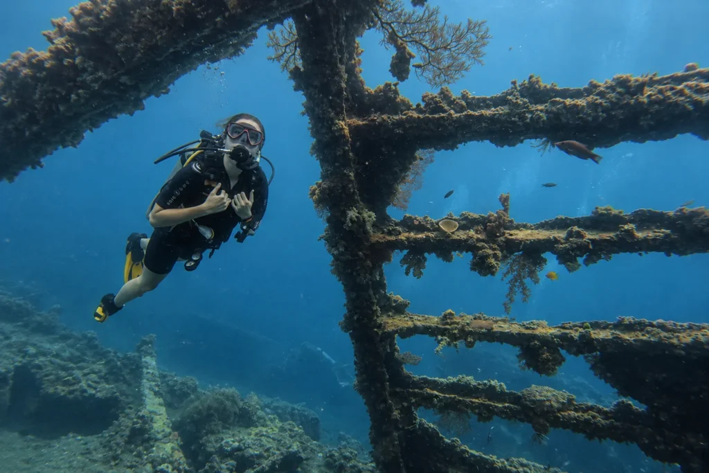 Diver exploring the USAT Liberty wreck during a PADI Advanced Open Water course in Bali