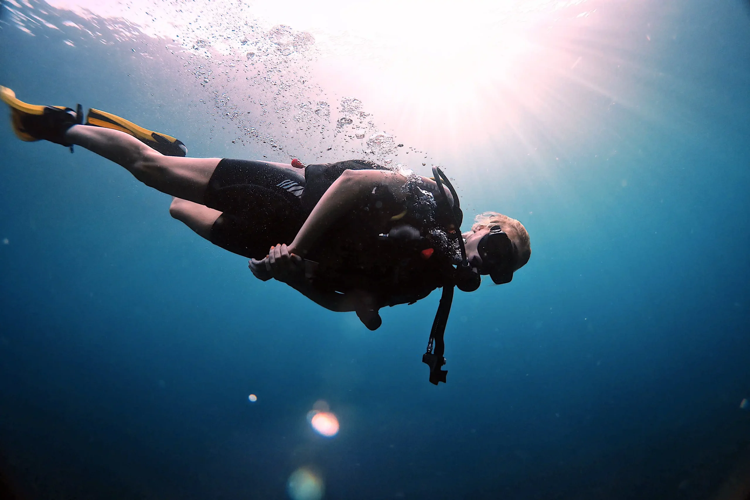 Scuba diver underwater at the USAT Liberty wreck in clear morning visibility in Tulamben, Bali